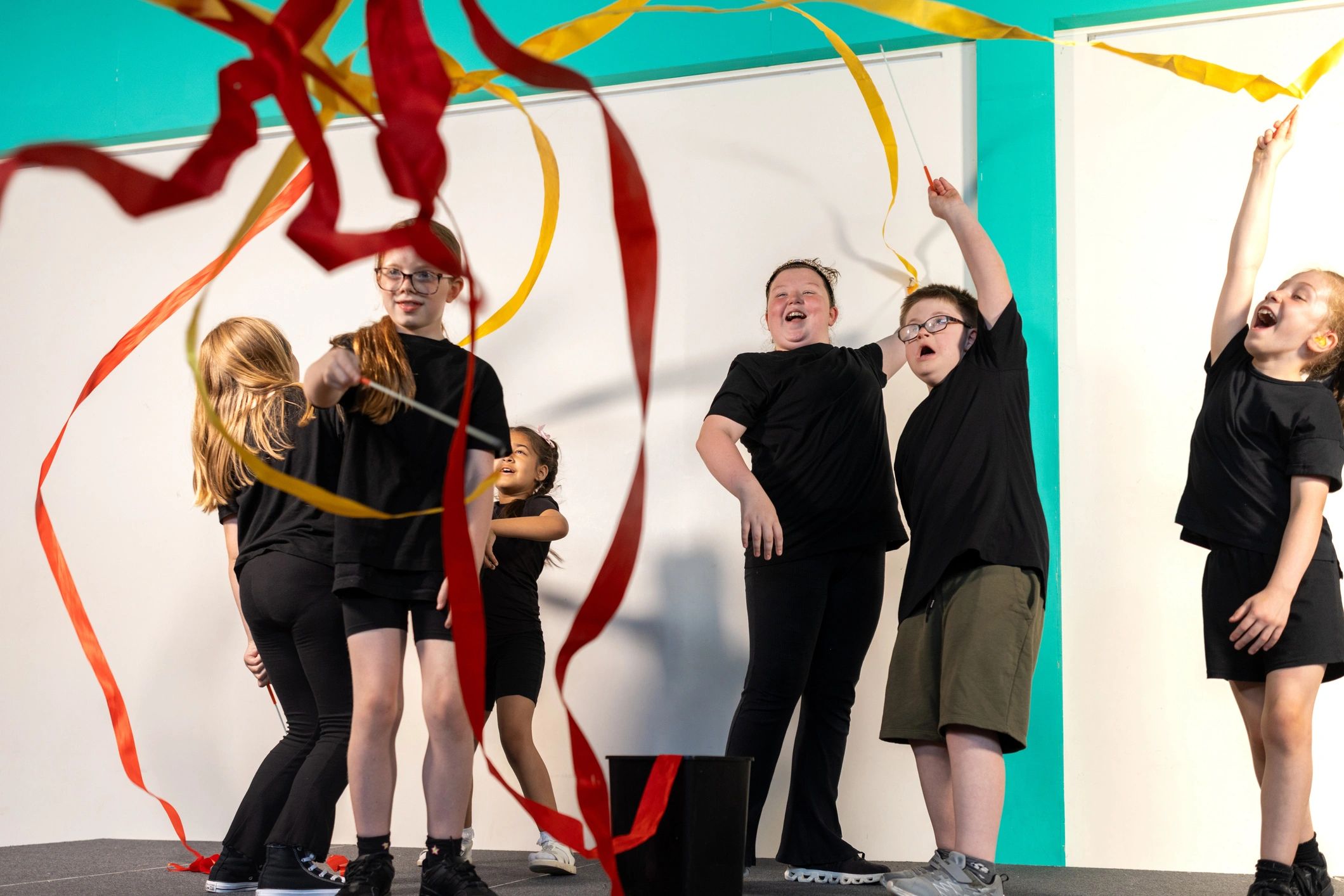 Young dancers practicing with ribbon props