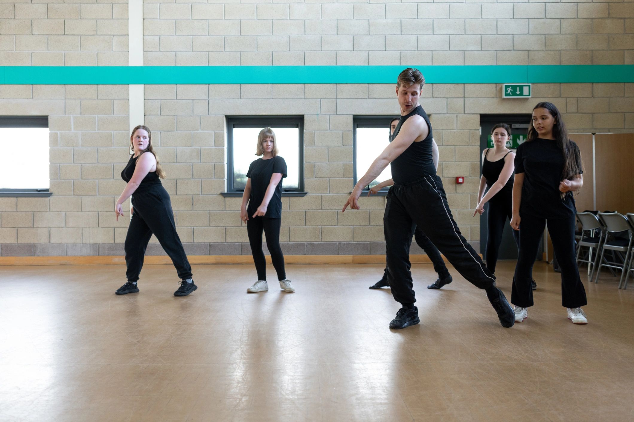 Teen dancers rehearsing together in formation